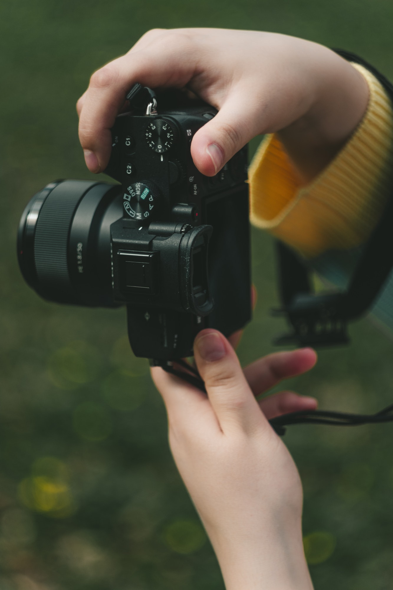 female hands holding a camera while filming